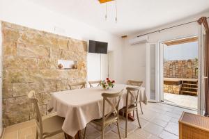 a dining room with a table and chairs at Villa Elena Nina by BarbarHouse in Torre Lapillo