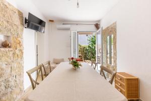 a dining room with a long table with chairs at Villa Elena Nina by BarbarHouse in Torre Lapillo