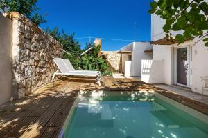 a villa with a swimming pool and a chair at Villa Elena Nina by BarbarHouse in Torre Lapillo
