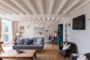 a living room with a couch and a table at The Coach House, Pentland Hills in Nine Mile Burn