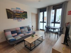 a living room with a couch and a table at Sella Rooms in Arriondas