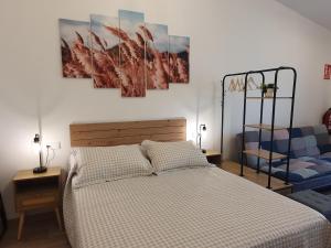 a bedroom with a bed and a blue chair at Sella Rooms in Arriondas