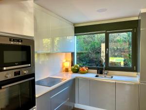 a kitchen with a sink and a window at Casa Libao in Arrieta