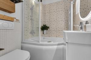 a bathroom with a tub and a toilet and a sink at Hidden Garden , Stylish Stay in Makarska Old Town in Makarska +36 photos