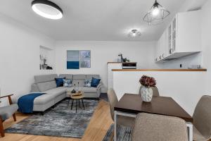 a living room with a couch and a table at Hidden Garden , Stylish Stay in Makarska Old Town in Makarska