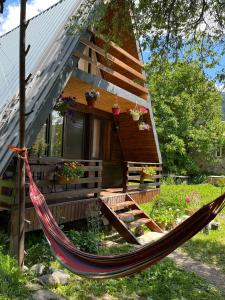 a hammock in front of a tiny house at Cottage Mida in Mestia