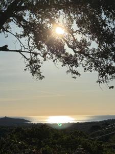 a view of the sun setting over the water at CASA ANPÀ Maison Vue Mer in Lecci