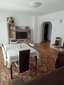 a living room with a table and chairs at Sunny Apartment in Predeal
