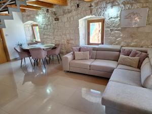 a living room with a couch and a table at apartman "Dora" in Rogoznica