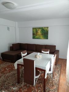 a living room with a table and a couch at Sunny Apartment in Predeal
