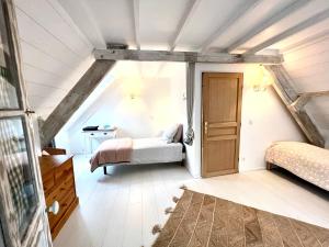 a bedroom with two beds in a attic at Les jardins du Tôt in Fermanville +6 photos