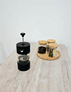 a table with three jars on top of it at Apartaestudio tipo Loft tranquilo cerca al Parque in Armenia +13 photos