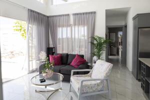a living room with a couch and a table at Book Villa 1002 Luxury in Sosua in Sosúa