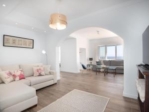 a living room with a white couch and a table at Domus A B 6 Pax in Portocolom