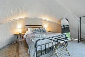 a bedroom with a bed in a small room at Cloud Nine Tent #2 - The Spruce Suite in Hermosa
