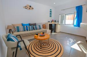 a living room with a table and a couch at Tre Fiori - The Retreat Suites in Fira