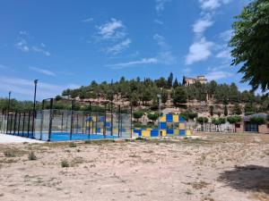 a playground in a park with a hill in the background at Ca la Inés in Corbera