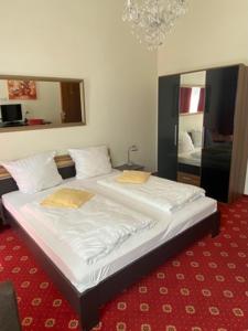 a large bed in a room with a red carpet at Hotel Bernkasteler Hof in Bernkastel-Kues