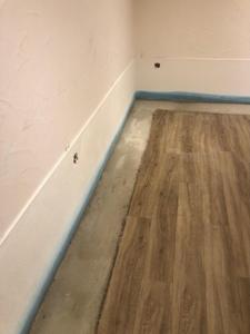 a room with a wooden floor and a white wall at Hotel Bernkasteler Hof in Bernkastel-Kues