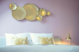 a bedroom with a bed with plates on the wall at LeonArt Living 51 in Graz +30 photos