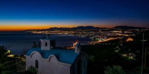 a church with a view of a city at night at Azure Loft in Rodhiá