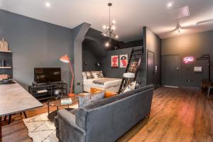 a living room with a couch and a bed at Large Studio Apartment, Free Parking, Close to Centre in Southend-on-Sea +8 photos