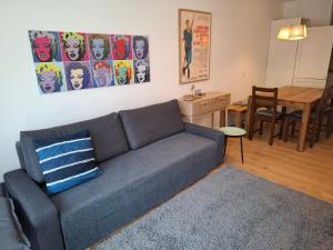a living room with a couch and a dining room table at Panorama Apartment Grenzberg in Bad Gastein
