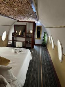 een slaapkamer met een groot bed en een spiegel bij Ferme hasna in Lubumbashi