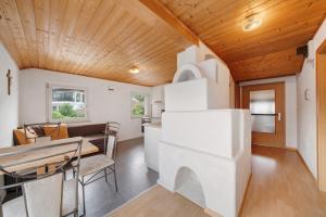 a kitchen and dining room of a tiny house at Ferienwohnung Bergblick-schlosshof in Vollan
