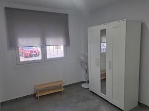 a room with a white cabinet and a window at Casa María in Vejer de la Frontera
