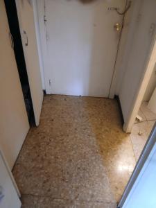 a hallway with a tile floor and a white door at Appartement proche centre ville 10min à pied de la mer in Mandelieu-la-Napoule