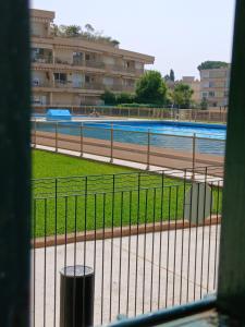 a view of a swimming pool from a window at Appartement proche centre ville 10min à pied de la mer in Mandelieu-la-Napoule