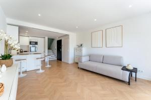 a living room with a couch and a kitchen at Vale Do Lobo Resort in Vale do Lobo