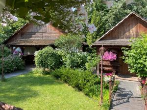 a garden with a wooden pavilion with flowers at Charivna Taistra in Brovary