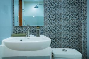 a bathroom with a white sink and a mirror at Upper Bliss Homestay in El Nido +12 photos