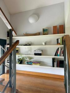 a living room with white shelves with books at Casa Libao in Arrieta