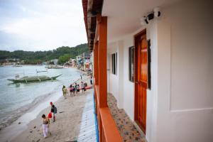 a group of people walking on the beach at Upper Bliss Homestay in El Nido