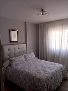 a bedroom with a bed and a window at Luz de Guía in Burela de Cabo