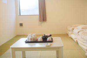 a room with a table with a tea set on it at 花乃郷 池袋f in Tokyo