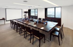 a large conference room with a large table and chairs at Beijing New World Centre Tongpai Hotel in Beijing