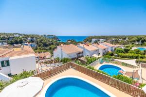 an image of a villa with a swimming pool and the ocean at Villa Carolina in Alaior