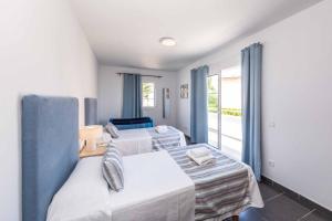 a bedroom with two beds and a large window at Villa Carolina in Alaior +45 photos
