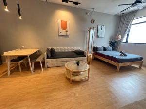 a living room with a couch and a table at Chambers by Lumira Haven Klcc in Kuala Lumpur