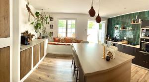 a kitchen with a table and a couch in a room at Baionako extea in Bayonne