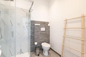 a bathroom with a toilet and a glass shower at Sea View Barcola in Trieste