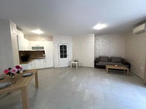 a living room with a couch and a table at Nikol Apart in Balchik +15 photos
