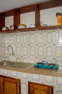 a kitchen counter with a blue item on the counter at studio CHEZ VOUS in Lomé +9 photos