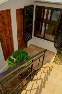 a bench in front of a house with a plant at studio CHEZ VOUS in Lomé