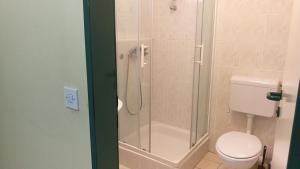 a bathroom with a toilet and a glass shower at Hostel Rožna dolina, Dom XIV in Ljubljana +14 photos