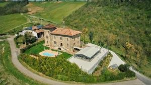 an aerial view of a house with a swimming pool at Tenuta Il Poggio - Luxury B&B in Felegara
